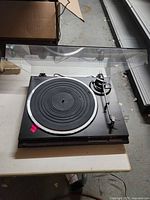 Top view of Technics SL-QD33 turntable with dust cover open showing platter and tonearm