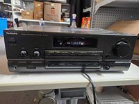 Front view showing Technics branding, model SU-G75 label, display lit, control buttons and knobs