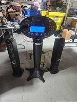 Full view of karaoke pedestal and two tower speakers