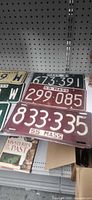 Green 63 MASS, maroon 55 MASS plates on shelf