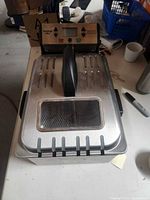 Closed fryer showing lid with window and stainless housing