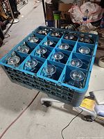 Blue rack holding sixteen wine glasses