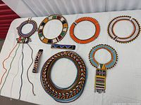 Overview of six collars and two cuffs displayed on table