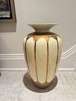 Front view of cream and gold ceramic floor vase