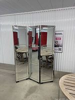 Front view of 3-panel mirrored divider standing partially folded
