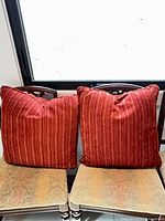 Both pillows side by side on chairs