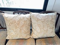 Both Ralph Lauren embroidered pillows on chair