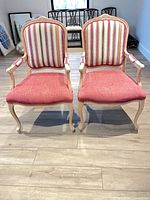 Front view of both armchairs showing upholstery and frame style