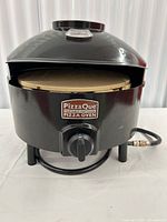 Front view of assembled PizzaQue oven with stone visible inside