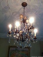 Chandelier installed and illuminated showing overall design and crystal prisms