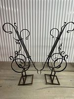 Pair of wrought iron garden sculptures standing side by side