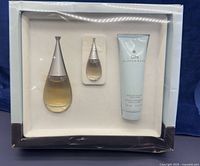 Front view of boxed gift set showing full-size eau de parfum bottle, mini bottle, and body lotion