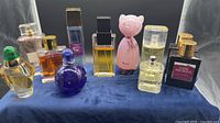 Group shot showing all perfume bottles on blue cloth