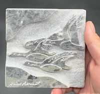 Front view of square relief showing three geese in flight