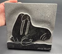 Front view of the rectangular stone carving showing entire walrus image