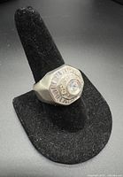 Front view of sterling silver signet ring on display stand