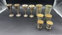 group shot of nine silver-tone goblets and cups