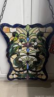 Full view of stained glass panel hanging on chain