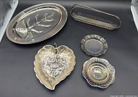 All five silver-plate pieces arranged