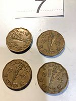 Four 1943 Canadian V 5-cent coins reverse side visible