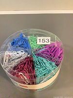 Top view of sealed tub showing six color sections of paper clips