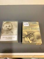 Both boxed decks side by side, lids removed on one to show cards