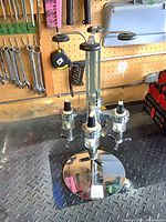 Full view of chrome liquor dispenser showing base, column and four arms