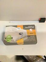 Front of boxed thermostat cover showing branding and lock image