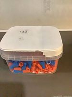 Translucent bucket with lid showing blue and orange wire connectors inside