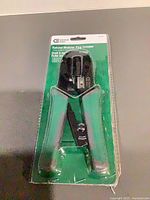 Front view of blister-packaged Commercial Electric ratchet modular plug crimper