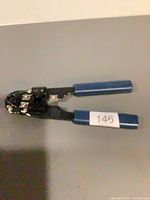 Full view of crimping pliers with blue handles