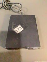 Top view of Dell external floppy drive with attached cable, showing wear