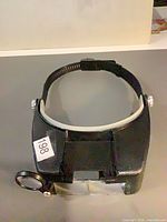Front view of headband magnifying visor showing flip lenses and loupe
