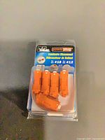 Front view of sealed blister pack showing five orange IDEAL connectors