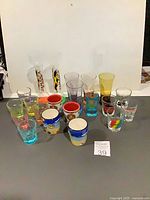 Full lot showing all approximately 20 shot glasses