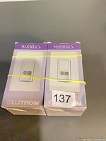 Front view of two boxed Lutron Maestro lighting control units
