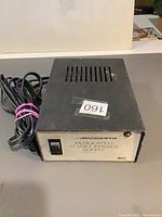 Oblique view showing top vents, attached power cord, front panel