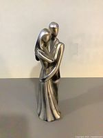 Front view of silver abstract couple figurine