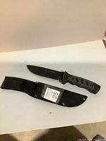 Knife and sheath laid flat