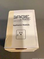 Front of SAGE by Hughes appliance module box showing branding and outlet icon