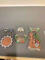 Front view of three German wine festival medals showing design and inscriptions