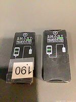 Front view of both boxed SMART Powerstik Mini chargers
