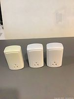 Front view of three Smartenit smart plugs showing outlet faces