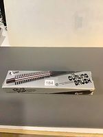 Box for Super The Curling Brush showing full product image and branding