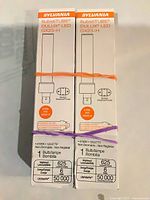 Front view of two sealed Sylvania GX23-H LED bulb boxes