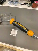 Full view of WeedComb weeder showing stainless head and handle