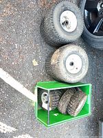 two larger wheels, green bin holding six smaller wheels