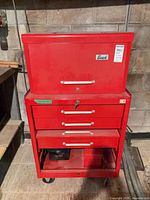 Front view of red Beach top box on rolling cabinet showing drawers and casters
