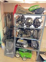 Full shelving unit with engines, decks, bag, handles