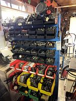 Full view of blue metal rack with bins and contents